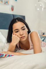 Young woman thinking about the plot of her book