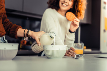 Young woman preparing breakfast for herself and her roommate