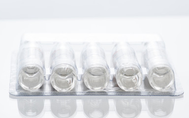 transparent ampoules for injection with medicine in package on a white background