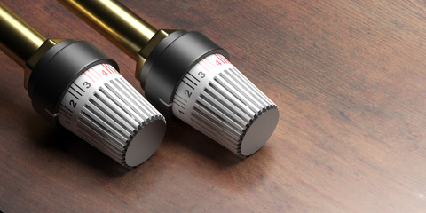 Obraz na płótnie Canvas Radiator thermostat on wood. Heating temperature control. 3d illustration