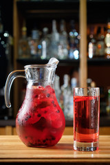 Different soft drinks in transparent jugs on a dark wooden background. menu for catering