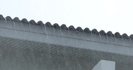 Rain from the roof of the house, heavy rain, stormy wind,