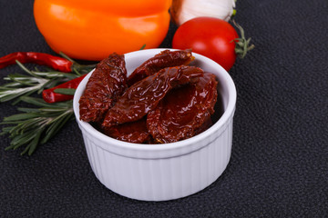 Dried tomatoes in the bowl with olive oil
