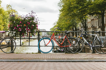 Fototapeta premium Bicycle parked on a bridge above the water in Amsterdam