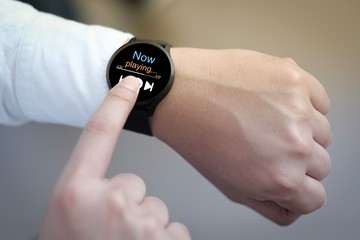 A man listening music streaming on smart watch