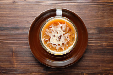 Cappuccino on a brown wooden background. Menu