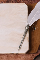 top view of metallic nib on blank page of notebook