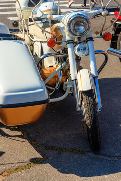 Retro tricar. Three-wheeled motorcycle on city street