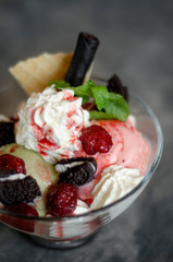 raspberry and pistachio ice cream sundae dessert in bowl