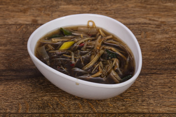 Thai style soup with meat and mushrooms