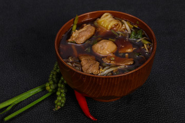 Thai style soup with meat and mushrooms