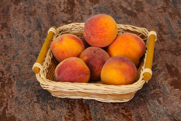 Peach heap in the wooden basket
