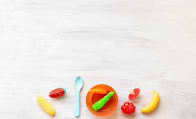 Infant baby food. With baby accessories and toys white background. Healthy food. Fruits an vegetables. Copy space.