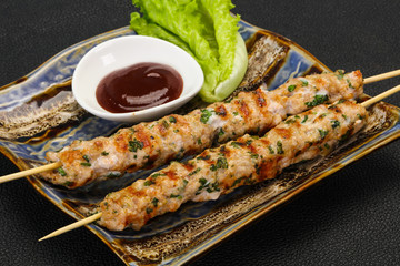 Minced pork skewer kebab with sauce