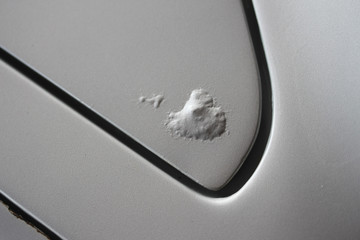 Rust bubbles on silver vehicle