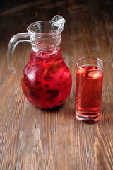Different soft drinks in transparent jugs on a dark wooden background. menu for catering