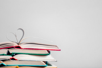 Old hardcover books. The pages of the book are folded in the shape of a heart. Learning concept. Love story.