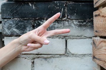 Girls hand showing pointing up two fingers, victory hand gesture