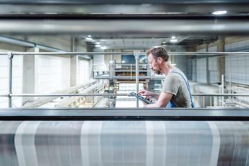 Engineer monitoring the printing press for a daily paper