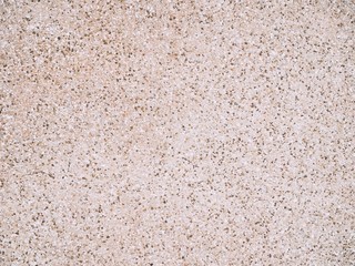 Closeup of cement wall in warm brown tone with texture of stone and gravel and rough surface for background and decoration. Cool banner on page, ad, presentation