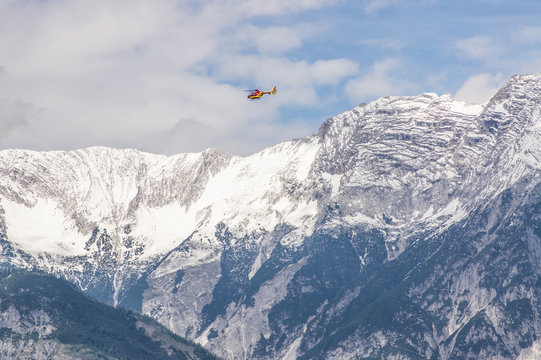 Rescue Helicopter in front of a mountain range,