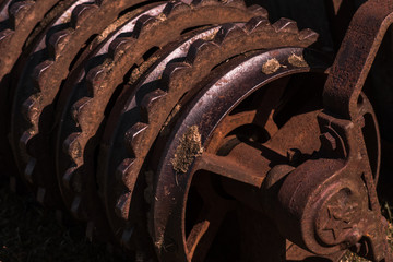 Fototapeta na wymiar Rusty old roller farm equipment