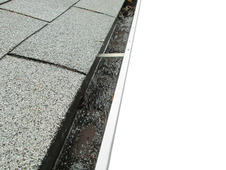 Gutter Clogged With Debris On A Roof