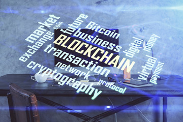 Double exposure of blockchain and crypto economy theme hologram and table with computer background....