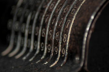 An old vintage cash register with lots of numbers