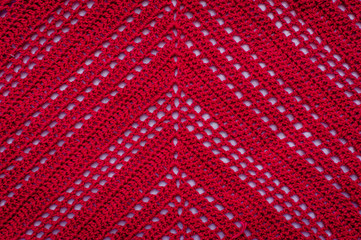 Detail of a crochet piece woven with red thread