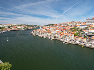 Fototapeta na wymiar Portugal, may 2019: Panorama from famous bridge Ponte dom Luis above Old town Porto and river Duoro at sunny summer day