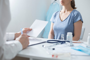 Woman at the consultation with a doctor. Female at the appointment with a gynecologist. Breast cancer concept.