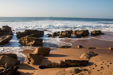 Fototapeta na wymiar Waves Breaking on Rocks on Durban Shoreline