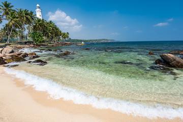 Fototapeta na wymiar Lighthouse and beautiful beach landscape in Sri Lanka