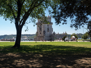 Fototapeta na wymiar Portugal, may 2019: Scenic Belem Tower and wooden bridge miroring with low tides on Tagus River. Torre de Belem is Unesco Heritage and icon of Lisbon and the most visited attraction in Lisbon
