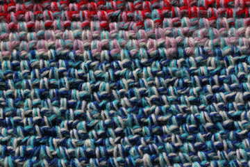 Crochet fabric background in blue, pink, and red