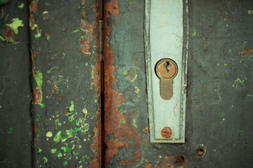 old iron door locked with metal shingle