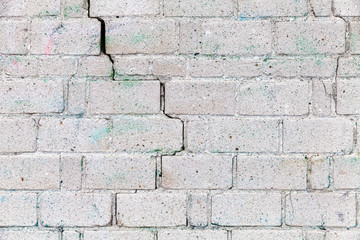 Old white brick wall with cracks