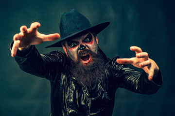 Fantasy horror Halloween. Halloween party and holiday concept. Vampire man with bloody eyes....