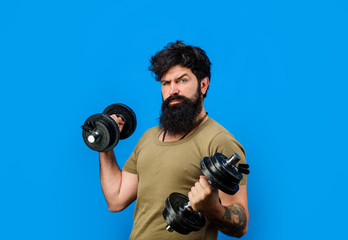 Fototapeta na wymiar Fitness model. Athletic man doing exercise with dumbbells. Strength and motivation. Handsome man lifting dumbbells at gym. Strong athletic man. Sporty man with dumbbells. Athletic guy with dumbbells.