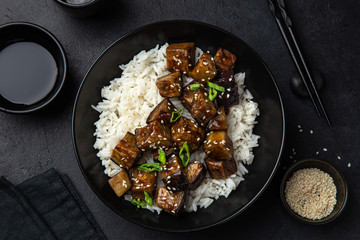 teriyaki eggplant with rice in black bowl