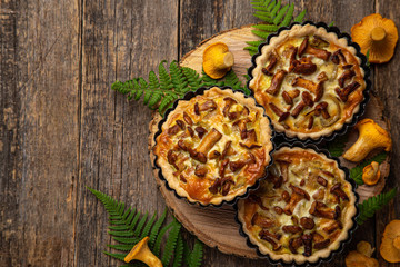 savory tartlets with chanterelle and onion  on wooden background