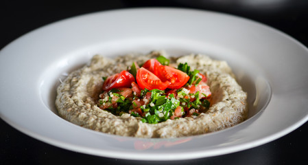 lebanese hummus dish with fresh vegetables, beef meat & pomegranate seeds