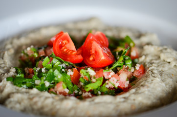 lebanese hummus dish with fresh vegetables, beef meat & pomegranate seeds