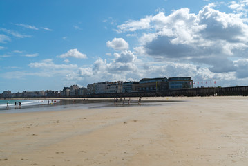 tourists enjoy a beautiful day on the beaches at Saint-Malo in Normandy during the long summer...