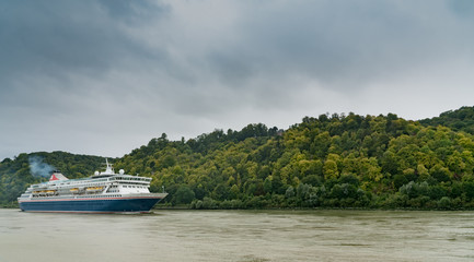 blue and white cruise ship traveling along the Seine River from Paris to the English Channel