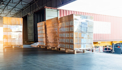 Packaging Boxes Wrapped Plastic on Pallets.  Trailer Truck Parked Loading at Dock Warehouse. Delivery. Shipping Warehouse Logistics. Cargo Freight Truck Transportation.	