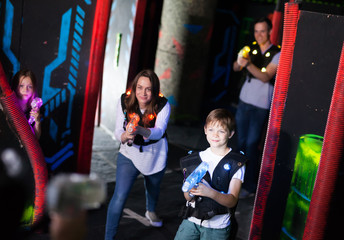 Fototapeta na wymiar Kids and adults on lasertag arena