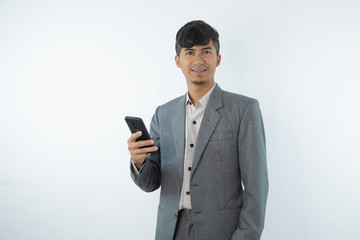 Portrait of asian young business man using smart cell phone isolated on white background.
