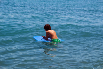 Boy on a blue sea.